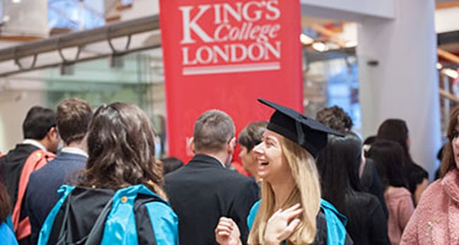 Smiling King's College London student attending graduation